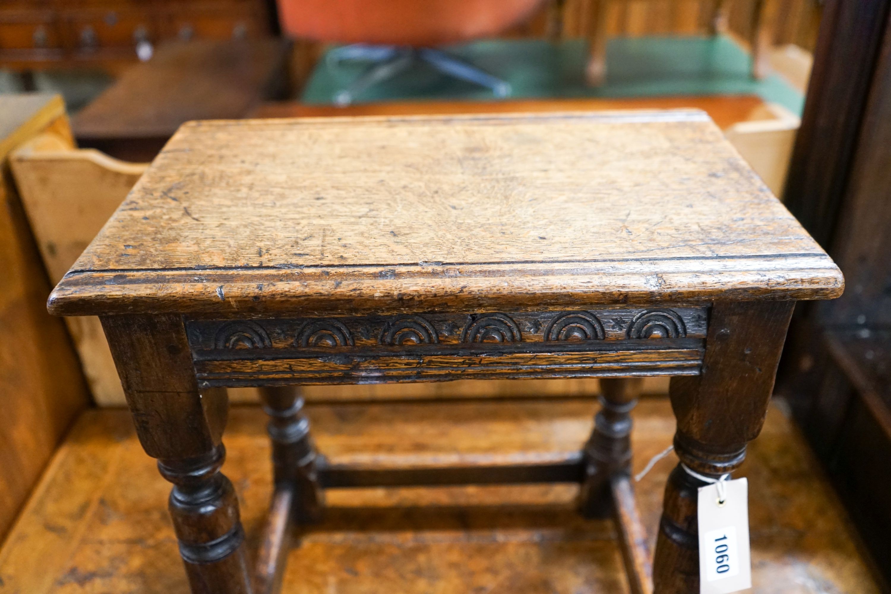 An 17th century style carved oak joint stool on turned supports, length 40cm, depth 25cm, height 45cm